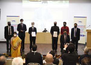 Group photograph of the signing ceremony Shri V.K. Yadav, Chief Executive Officer and Chairman Railway Board (on the screen) Right to Left (Top): Shri A.K. Bijalwan (Director/Finance), Mr. S.V. Desai (Whole time Director/L&T), His Excellency Shri Satoshi Suzuki, Ambassador of Japan to India, Shri Achal Khare, Managing Director/NHSRCL, Shri Vijay Kumar (Director/Rolling Stock, NHSRCL), Shri Rajendra Prasad (Director/Project, NHSRCL)   Right to Left (Bottom): Smt. K. Bhawani (Head - Metros Segment, Larsen & T