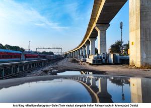 A striking reflection of progress—Bullet Train viaduct alongside Indian Railway tracks in Ahmedabad District