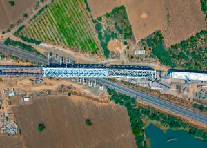 130 m long span of steel bridge launched over Indian railway tracks for Mumbai-Ahmedabad Bullet Train Project