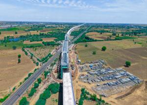 130 m long span of steel bridge launched over Indian railway tracks for Mumbai-Ahmedabad Bullet Train Project