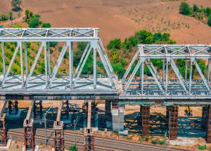130 m long span of steel bridge launched over Indian railway tracks for Mumbai-Ahmedabad Bullet Train Project